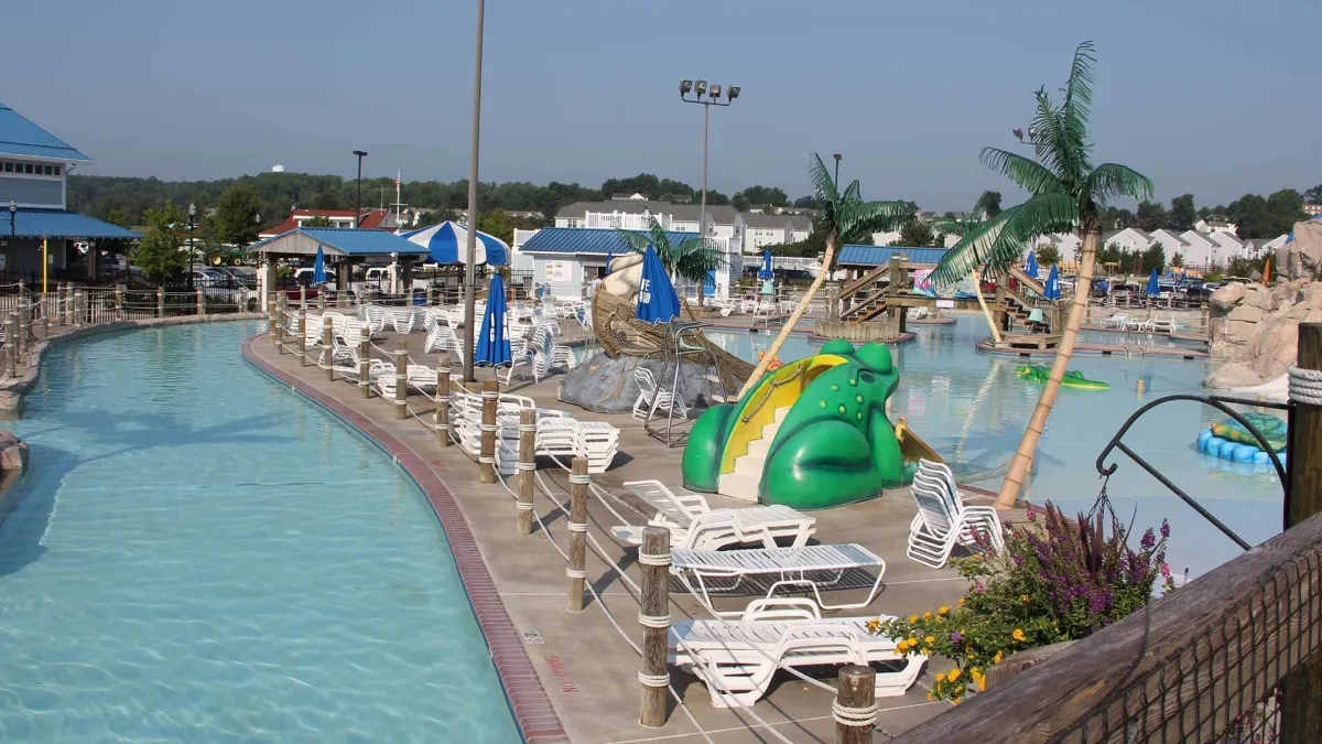 The Dreamland River lazy river winding past palm trees and the frog slide